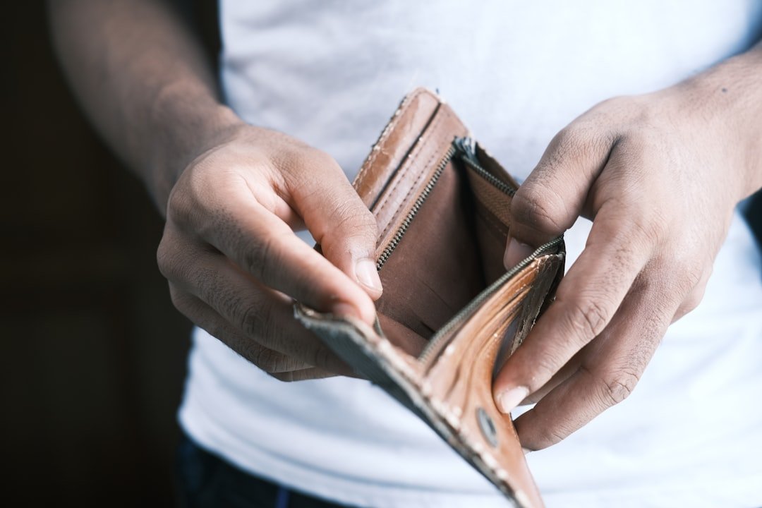 Photo by Towfiqu barbhuiya person holding brown leather bifold wallet